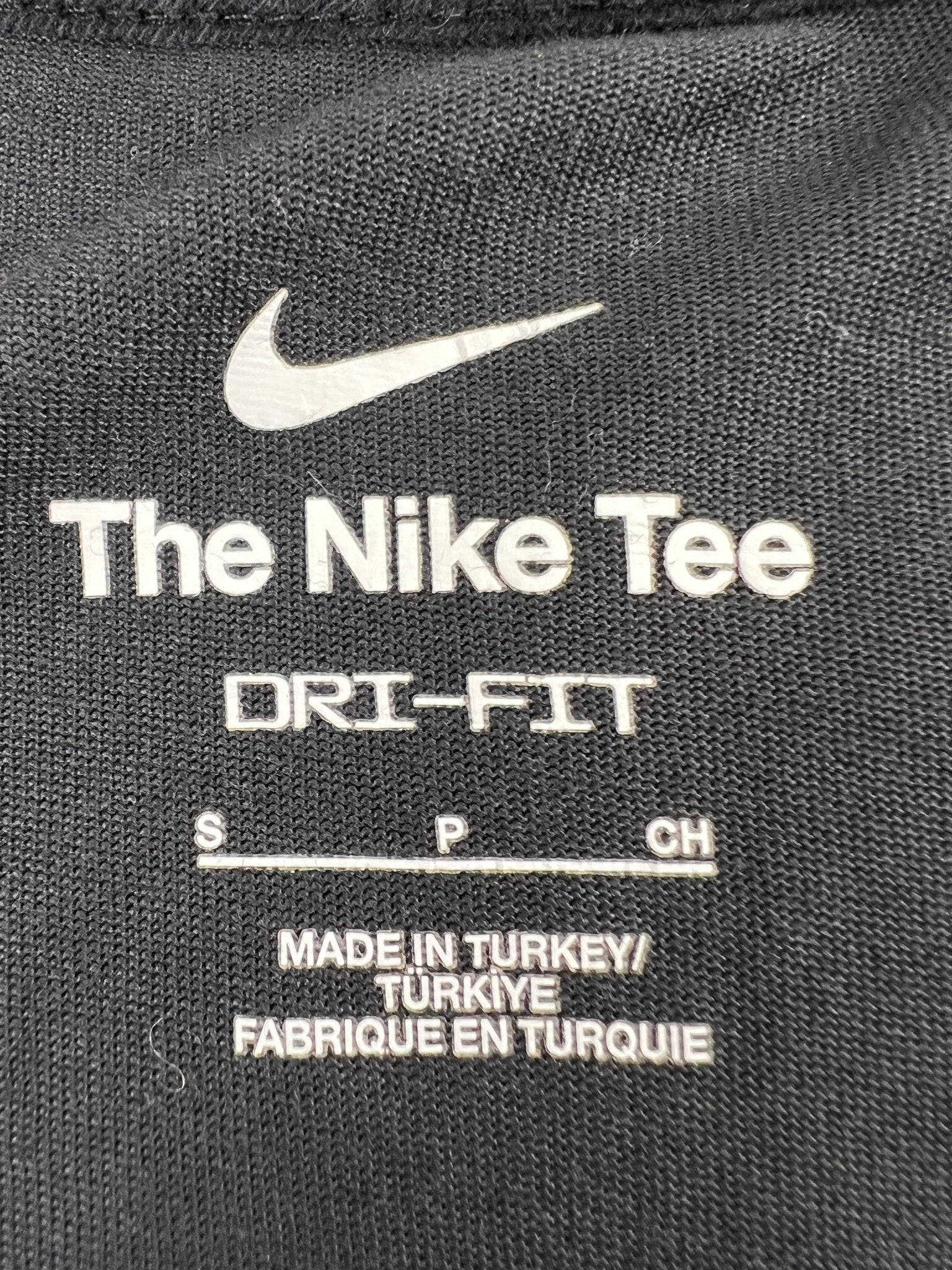 Close-up of internal label showing Nike Dri-FIT logo and manufacturing details