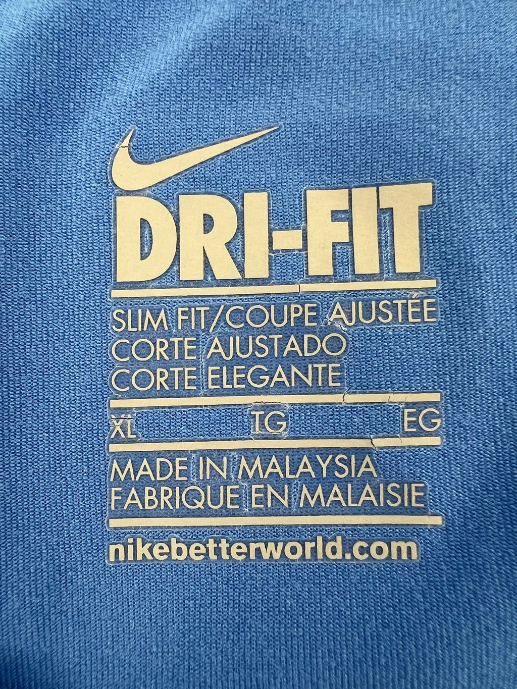 Close-up of Nike Dri-FIT care label with size XL and manufacturing details