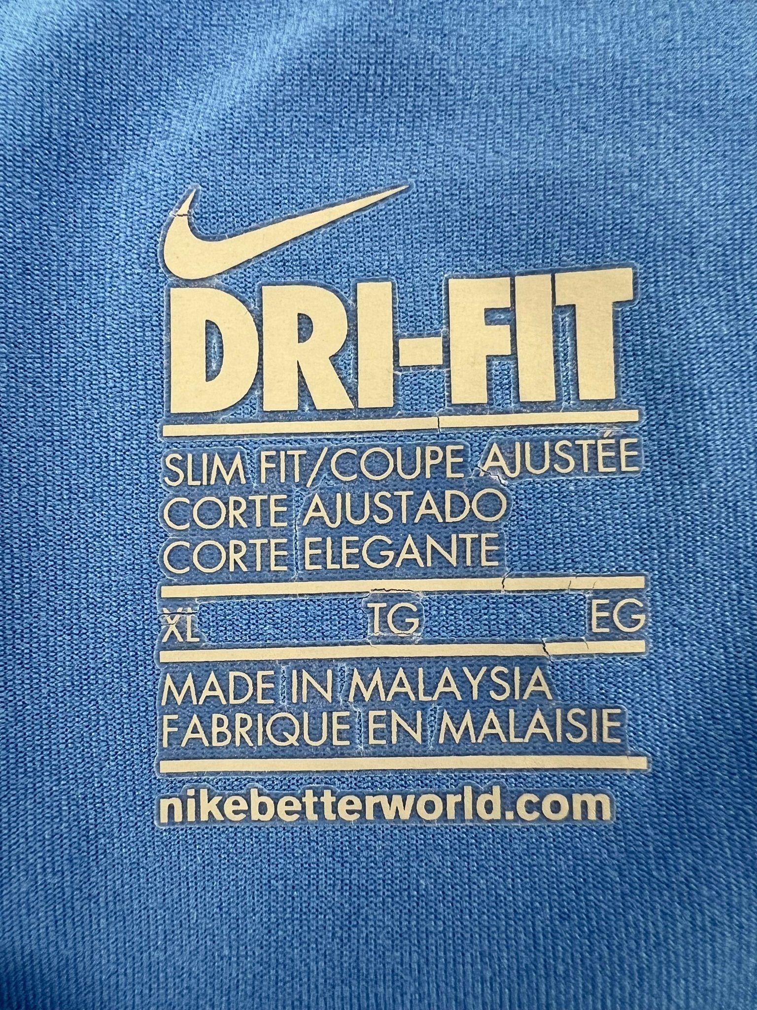 Close-up of Nike Dri-FIT care label with size XL and manufacturing details