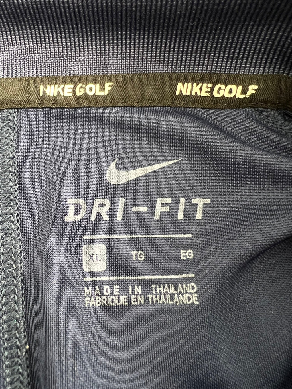 Close-up of Nike Golf Dri-FIT label inside shirt showing size XL