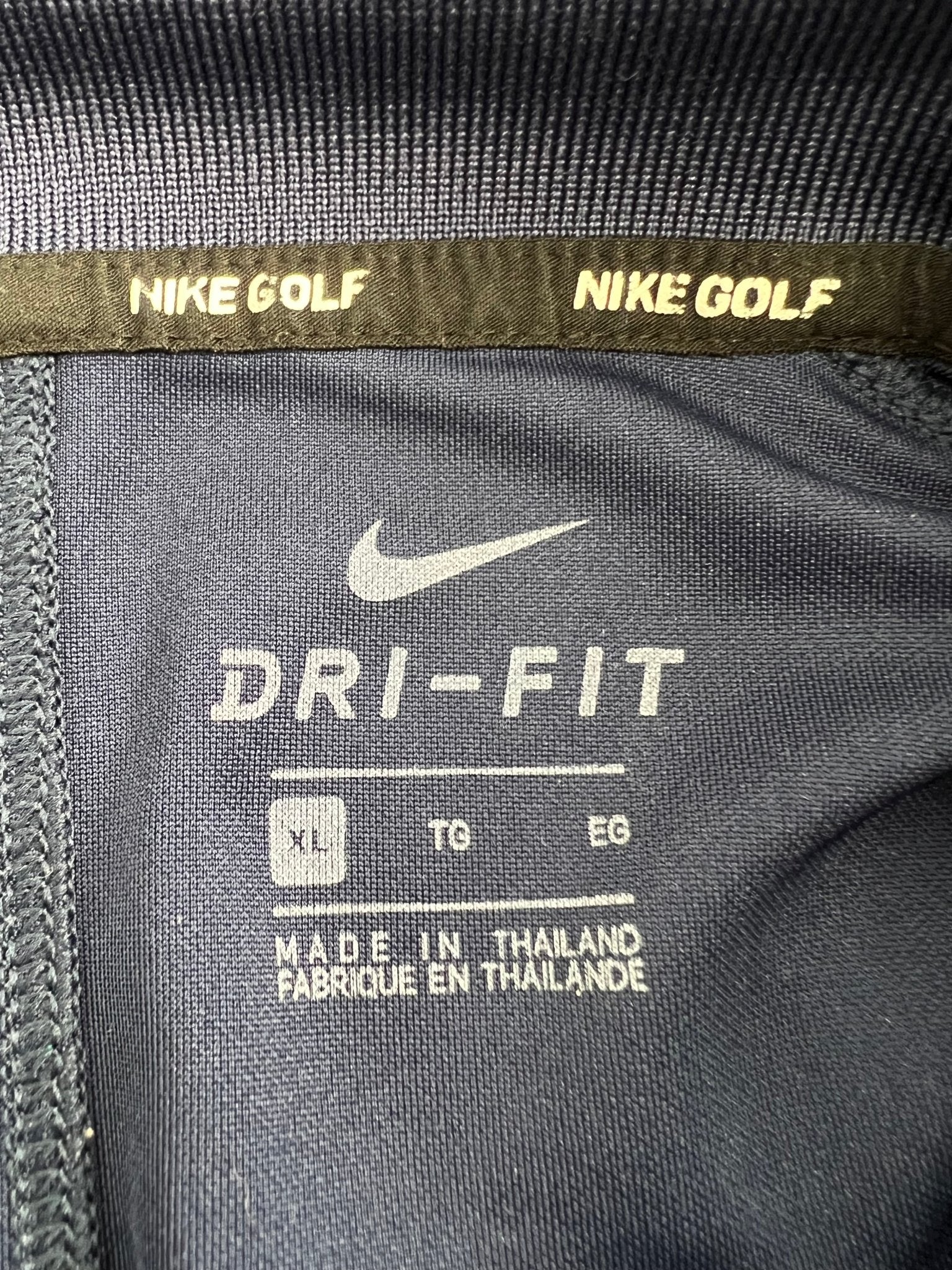 Close-up of Nike Golf Dri-FIT label inside shirt showing size XL