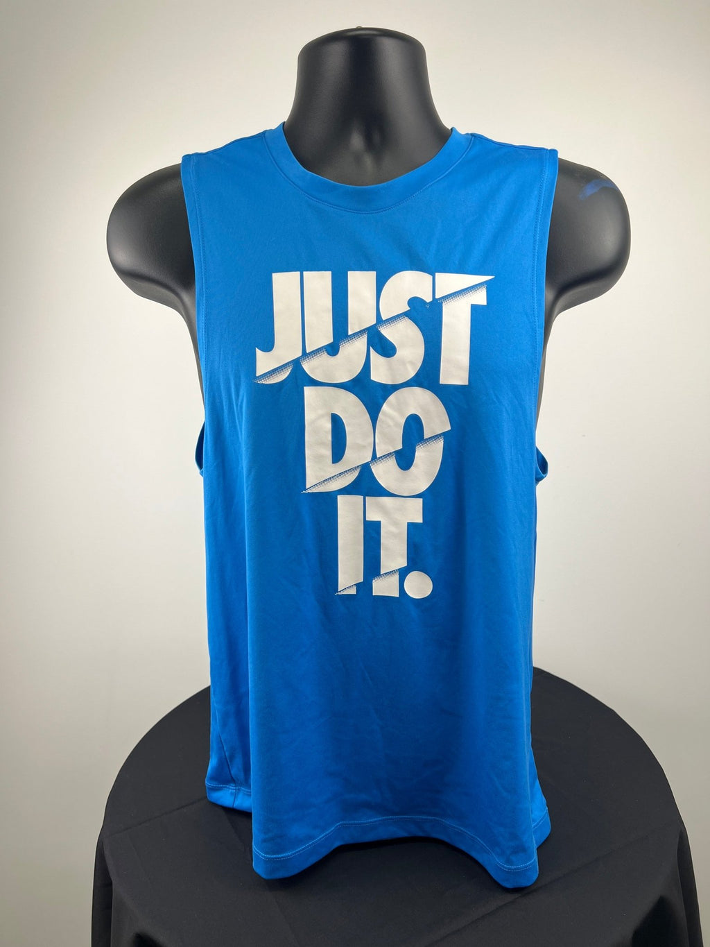 Front view of blue Nike Dri-FIT running vest with 'Just Do It.' print