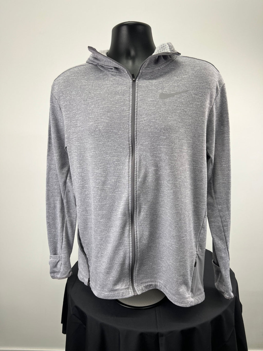 Front view of grey Nike running hoodie with zip and hood