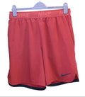 Nike orange running shorts with elastic waistband and black Nike logo
