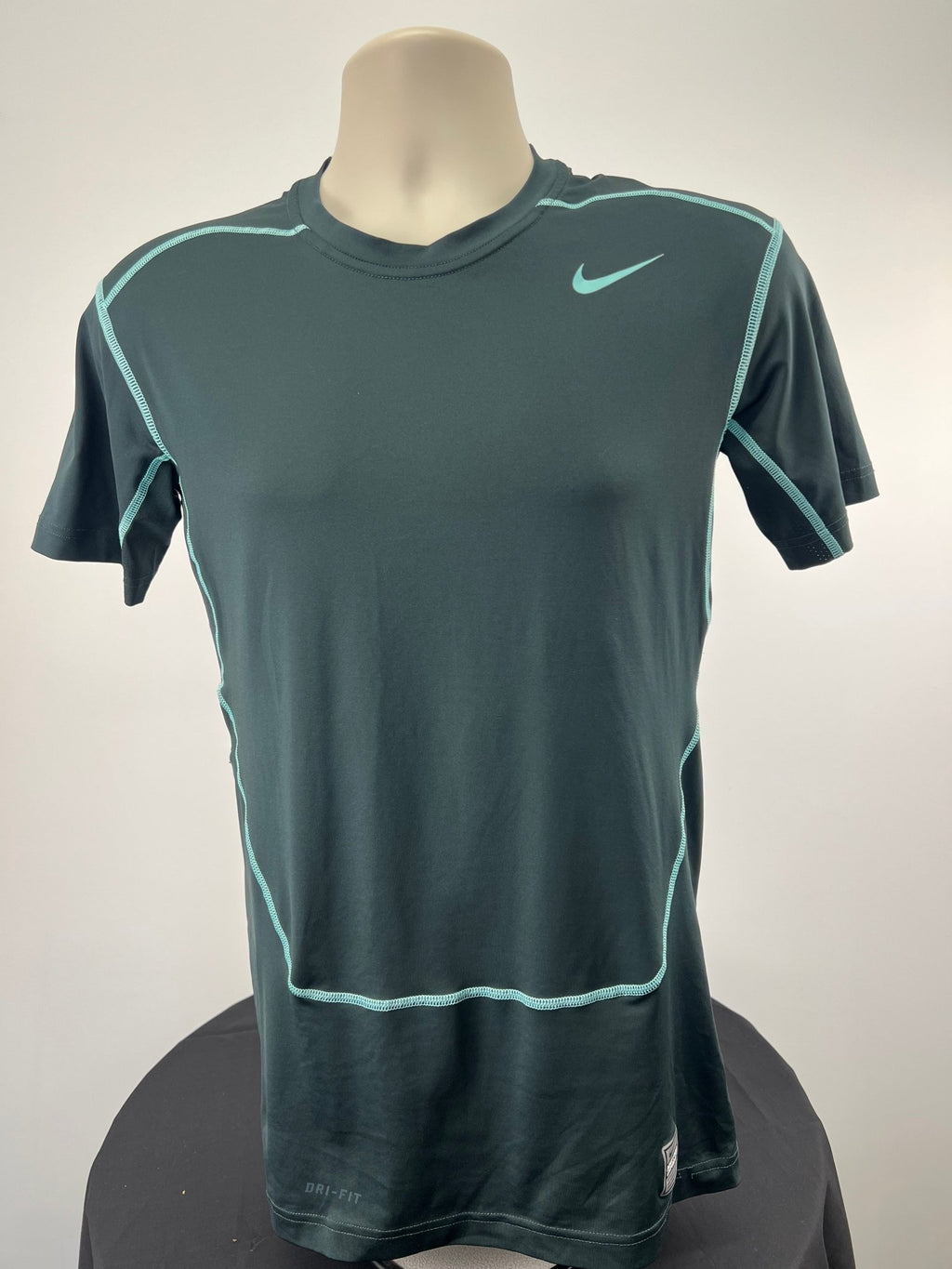 Front view of Nike Pro Combat compression top in size large, charcoal with teal accents