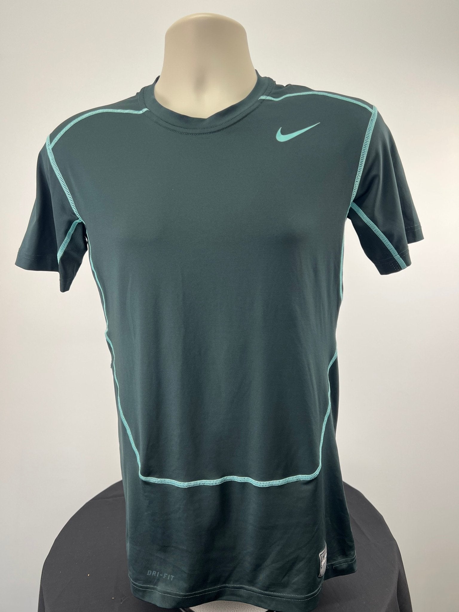 Front view of Nike Pro Combat compression top in size large, charcoal with teal accents