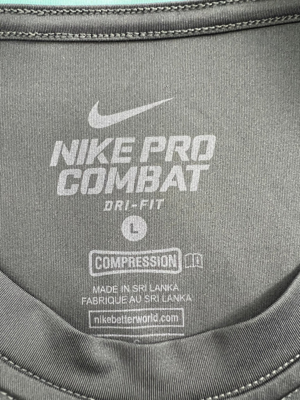 Close-up of Nike Pro Combat compression top inner label and size detail