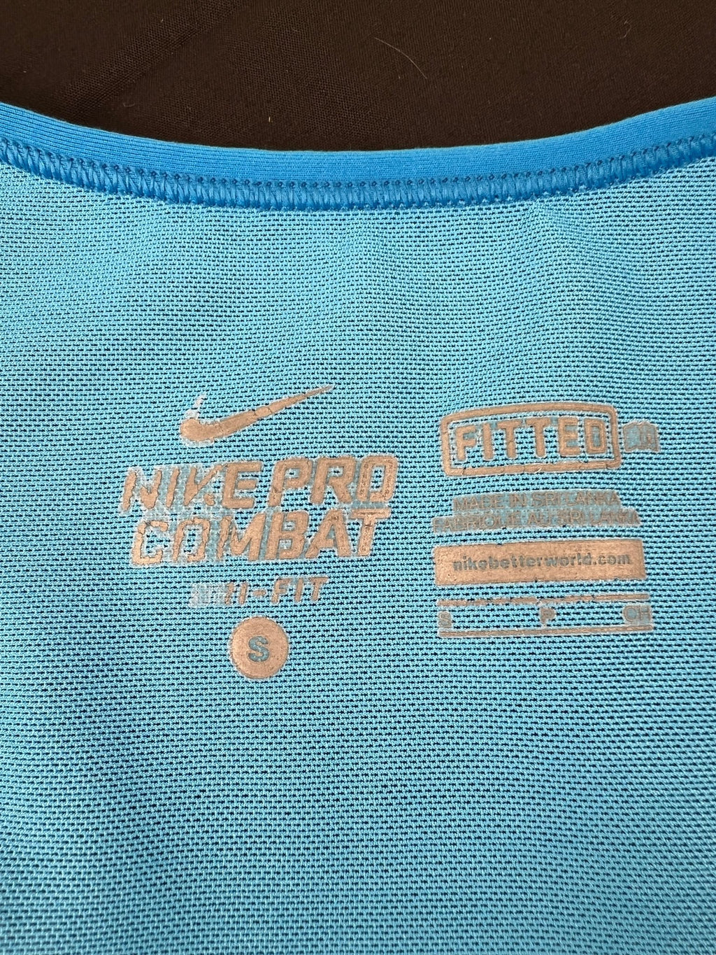 Close-up of Nike Pro Combat Dri-FIT label and size S inside the tank top