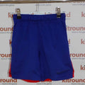 Front view of blue Nike Dri-FIT sports shorts with red mesh inserts, size XS