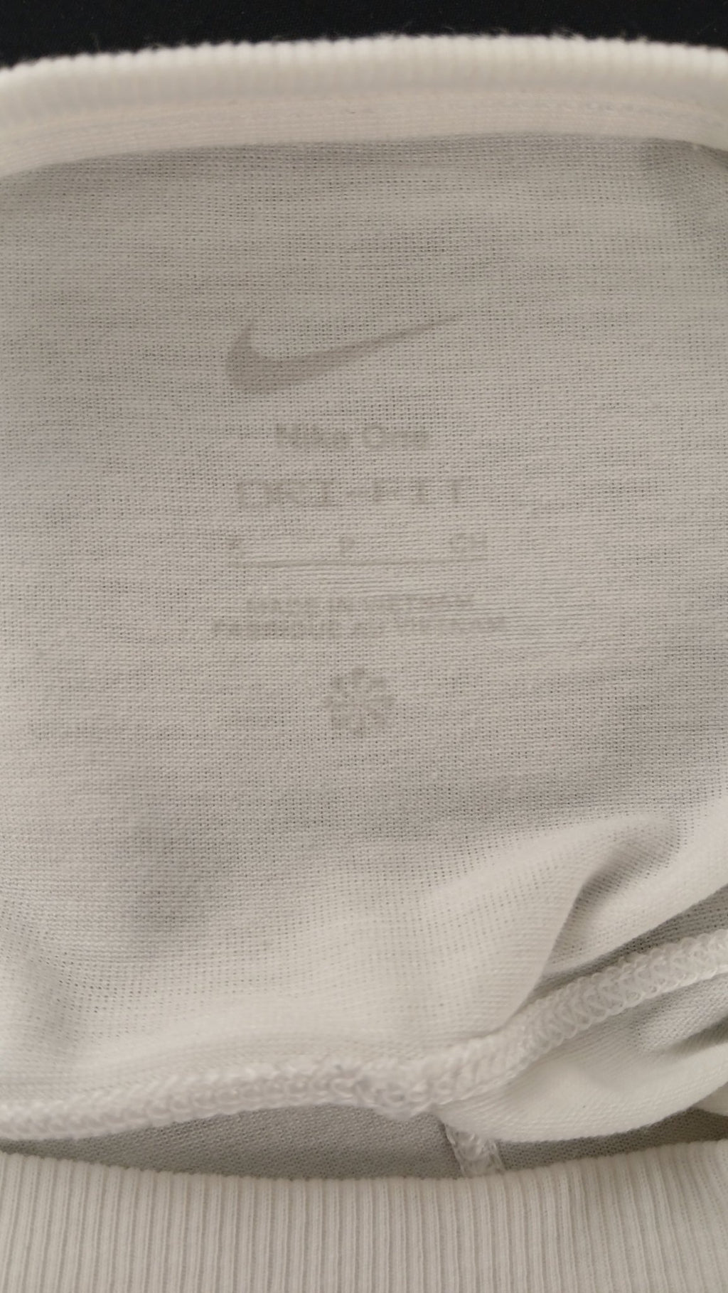 Interior label of white Nike T-shirt with Dri-FIT branding