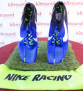 Pair of Nike Zoom Victory Elite blue racing spikes with green Nike Racing bag, top view