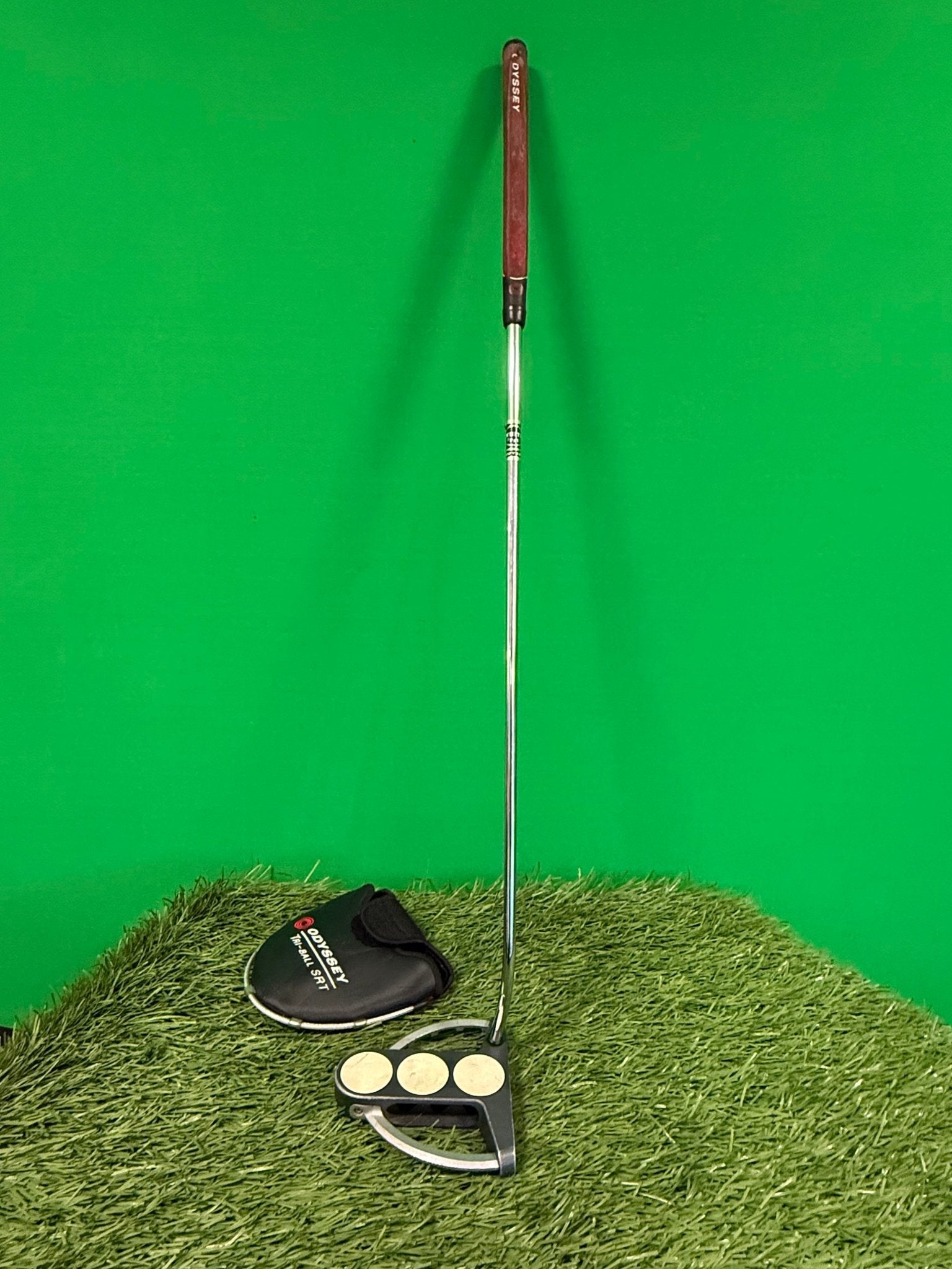 Full view of Odyssey Tri-ball SRT Putter with headcover on artificial grass