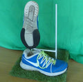 Side and sole view of blue Nike Air trainers with neon laces