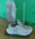 Pair of white Puma trainers on display showing sole and side profile