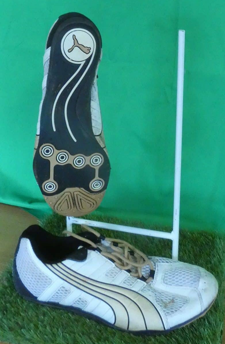 Bottom view of men's Puma running shoe showing black sole with circular grip patterns and Puma logo