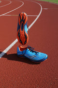 Pair of blue and orange Saucony Kilkenny XC4 running shoes, one shoe showing sole with visible spike plate