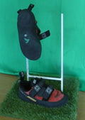 Pair of black and red Boreal climbing shoes displayed on artificial grass