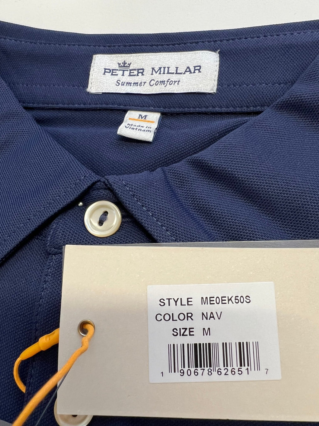Close-up of Peter Millar label and size tag with product information