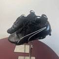 Pair of black Puma football boots with white stripes