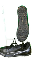 Black Puma astro turf football boot side view with rubber sole and white logo