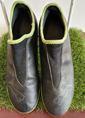 Top view of Puma laceless black football astro boots with lime green lining, size 5.5