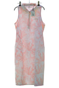 Puma sleeveless pink leaf print golf dress hanging on tennis court