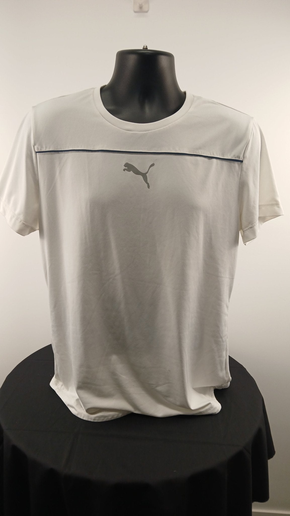 Front view of Puma white sports t-shirt displayed on a mannequin