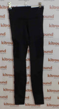 Front view of black Reebok sports leggings hanging on rail