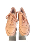 Front view of Reebok peach trainers with laces