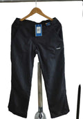 Front view of black Reebok waterproof short trousers on hanger