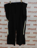 Ronhill black running trousers with reflective side panels hanging on a rail
