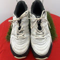 Pair of white Slazenger cricket shoes front view with laces on red cloth
