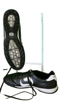 Pair of Sondico black and white astro turf football boots with a close-up of the grippy sole.