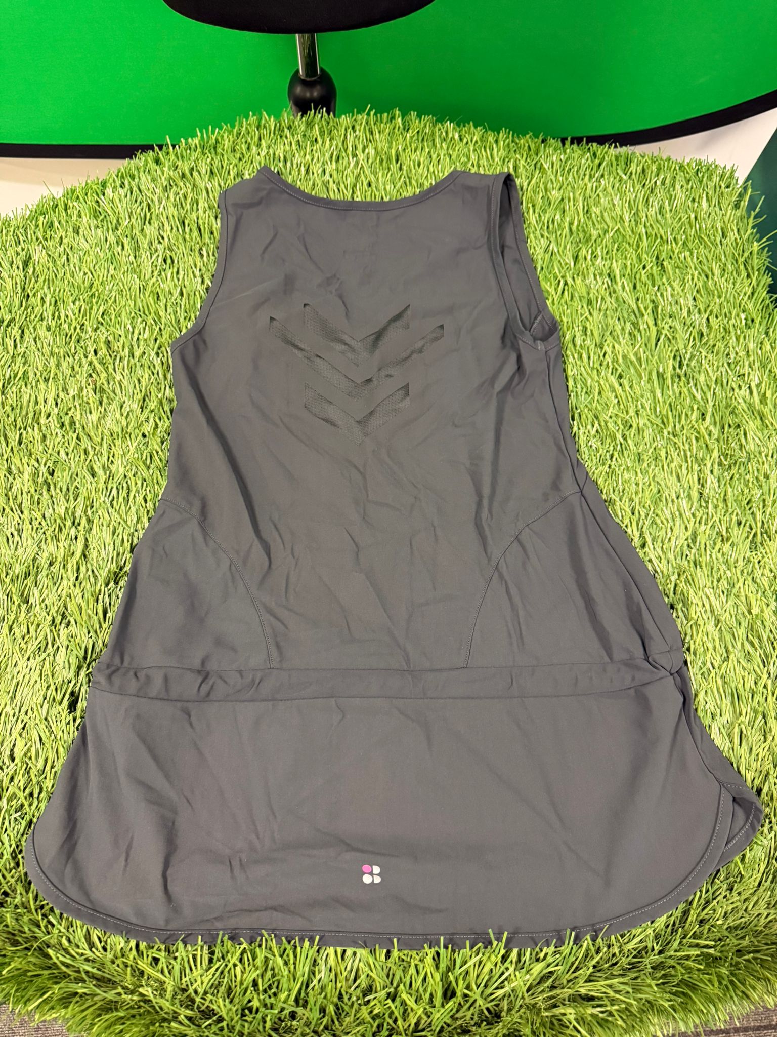 Back view of grey Sweaty Betty vest top featuring chevron ventilation pattern and logo