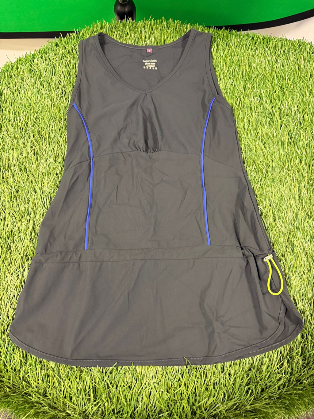 Front view of grey Sweaty Betty vest top with blue piping and yellow loop detail