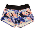 Sweaty Betty sports shorts with abstract blue and peach print, flat lay front view