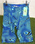 Pair of Speedo men's jammer swim trunks with a blue and green linear swirl pattern, displayed on a hanger on grass with tag attached.