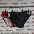 Two pairs of swimming trunks, adidas black with stripes and Seobean red with navy stripes displayed on hanger