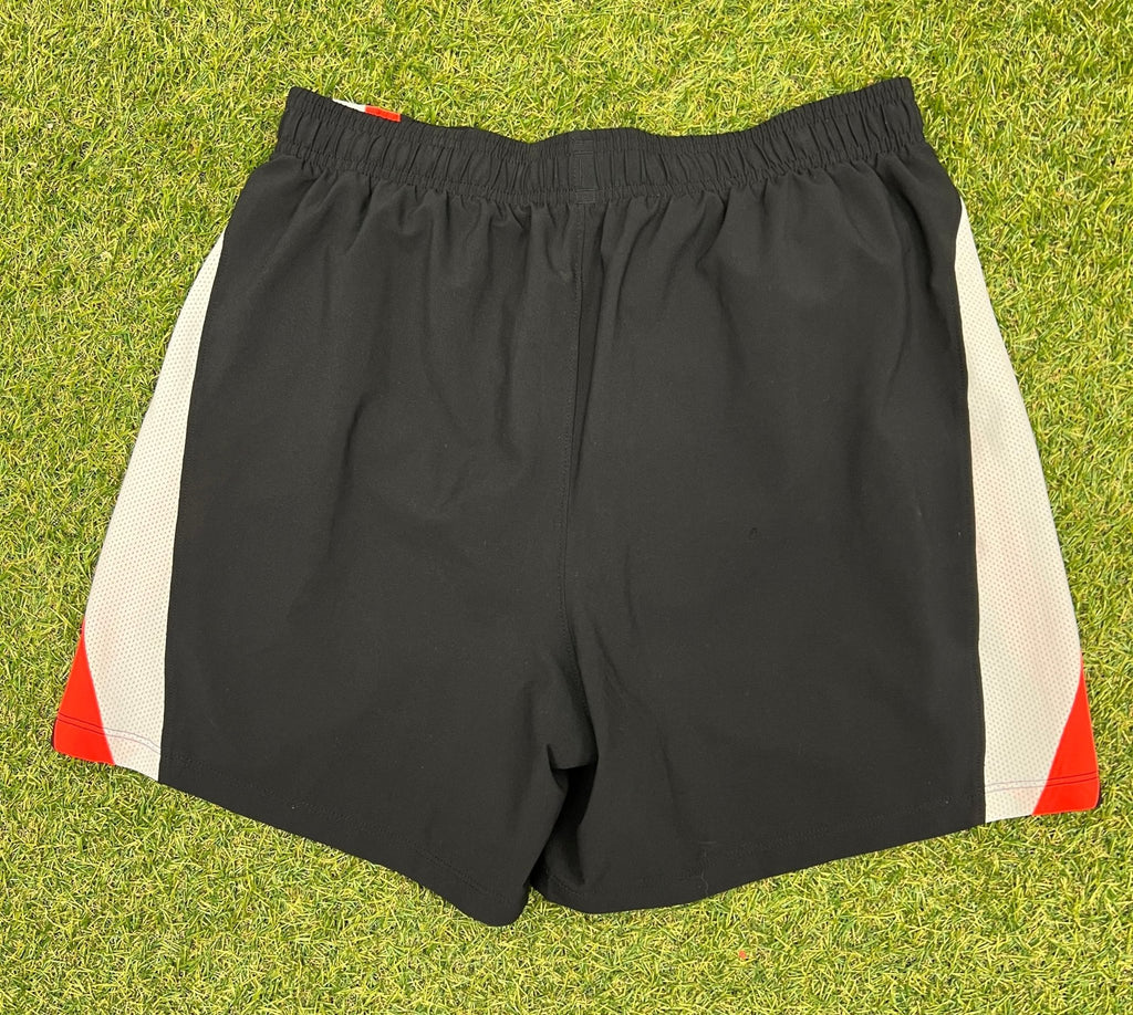 Back view of black Under Armour running shorts with mesh side panels