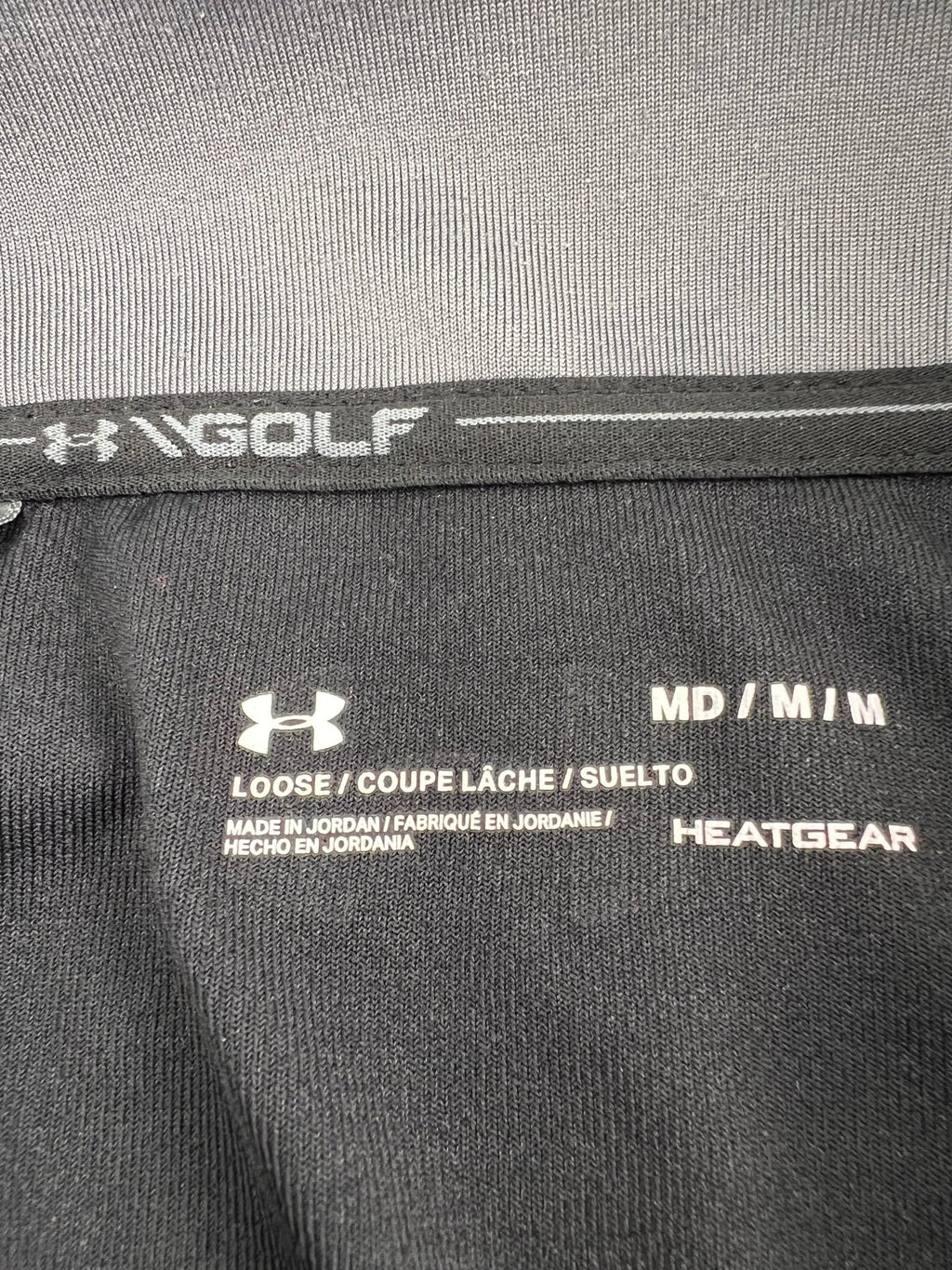 Close-up of Under Armour Golf HeatGear label and sizing tag