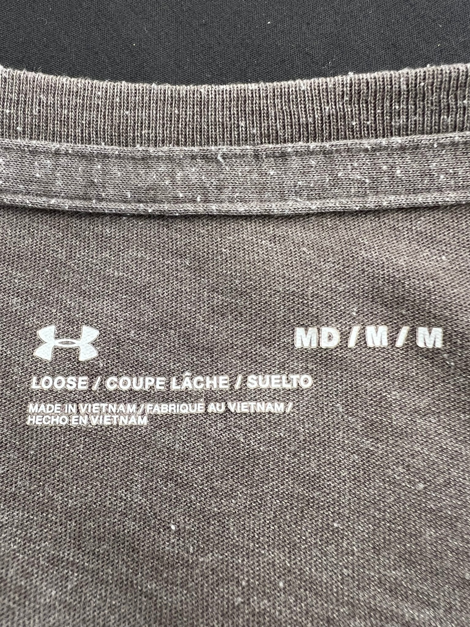 Close-up of inner collar tag showing size medium and care details