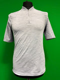Light grey mesh activewear top with 1/4 zip front and short sleeves displayed on a mannequin against green background