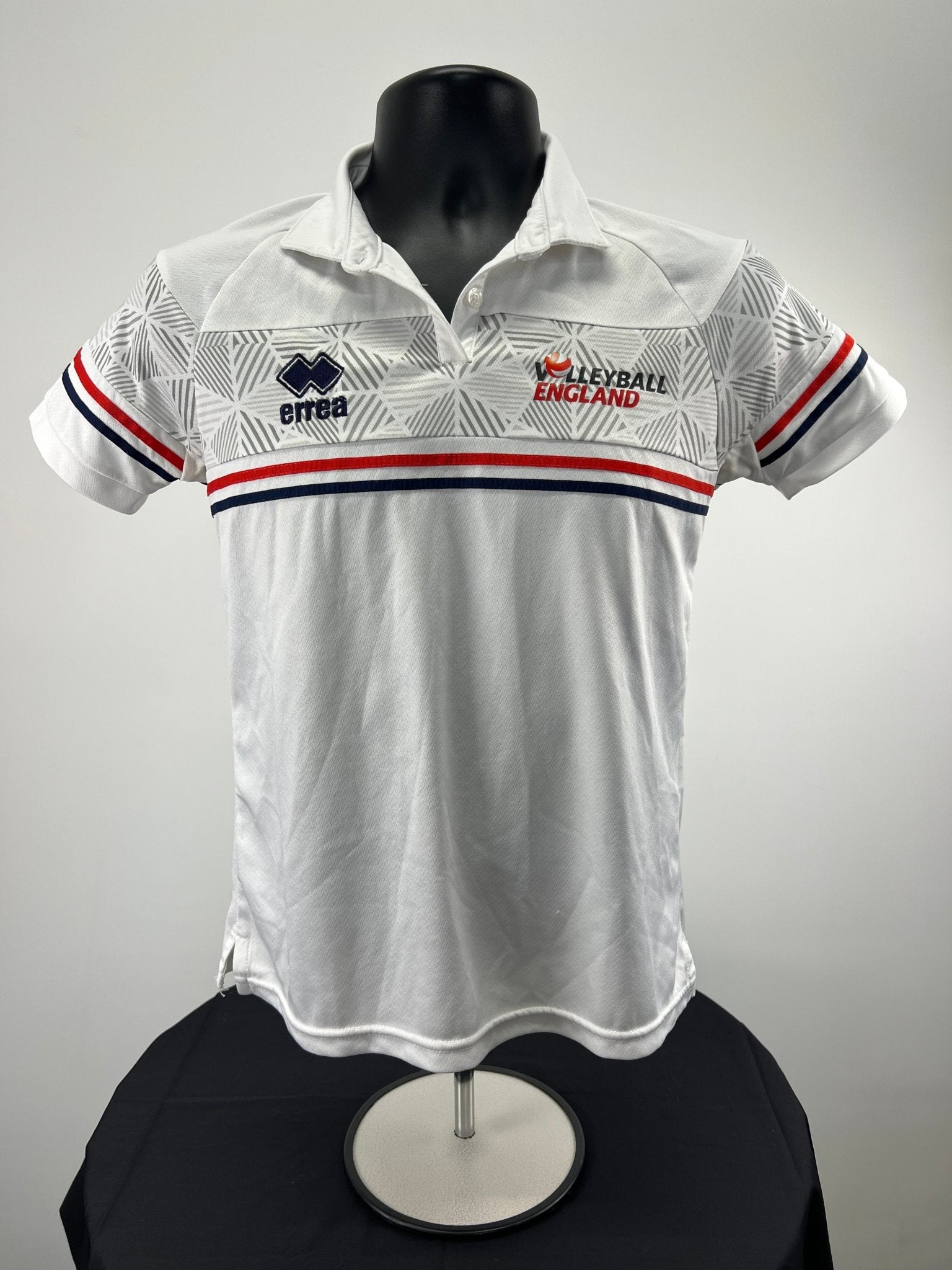 Front view of Volleyball England women's white polo shirt, size L, with red and blue stripes and geometric pattern