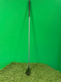 Wilson Deep Red 4 hybrid golf club standing upright on synthetic grass with green background