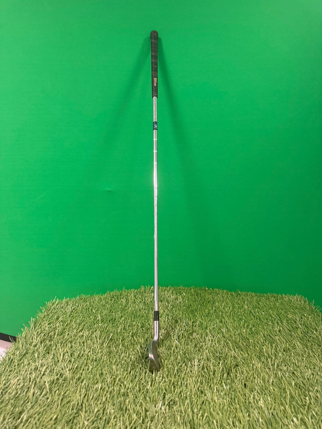 Wilson Prostaff oversize 4 iron golf club photographed on artificial grass with a green background