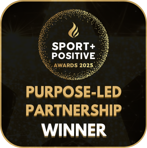 Award badge for 'Purpose-Led Partnership Winner' at Sport Positive Awards 2025 on a dark background.