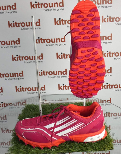 Adidas pink and red hockey shoes showing mud release sole for field sports