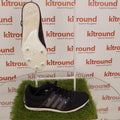 Black adidas running spikes with white spike plate displayed side and sole view
