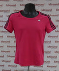 Front view of pink adidas Climalite women's short sleeve sports top with black stripes and logo