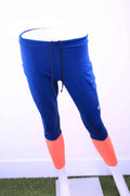 Front view of Asics blue and orange capri leggings with drawstring waist